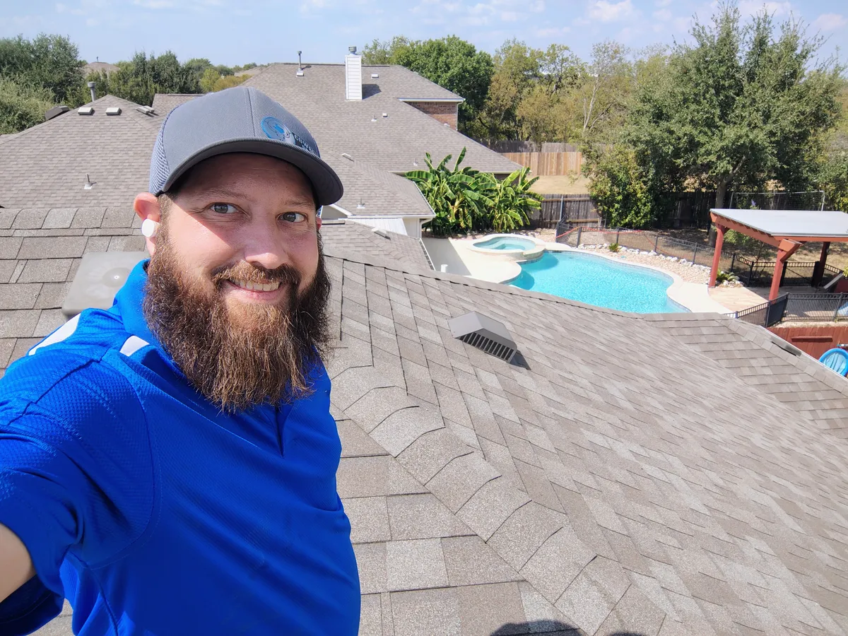 Ricky on a rooftop during a pest inspection in Central Texas